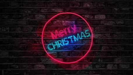 Neon Holiday Glow on Brick Wall wallpaper