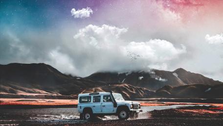 Adventurous Off-Road Journey Under Vibrant Skies wallpaper