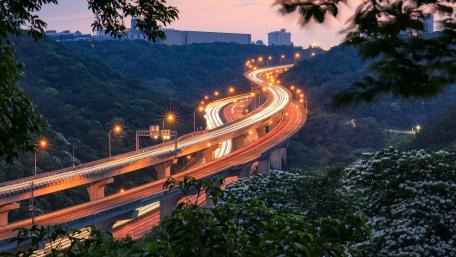 Curvy Overpass Illuminated by City Lights wallpaper