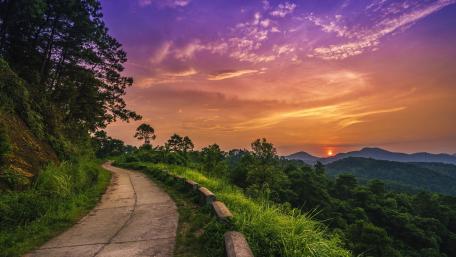 Serene Sunset Over Mountain Road wallpaper
