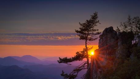 Majestic Sunset Over Mountain Cliff wallpaper