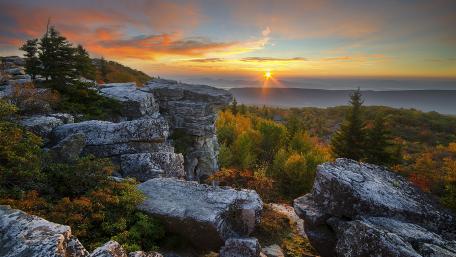 Majestic Autumn Sunrise Over Regal Cliffs wallpaper