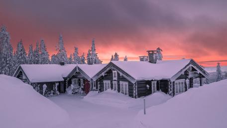 Snowy Sunrise over Winter Cabin Wonderland wallpaper