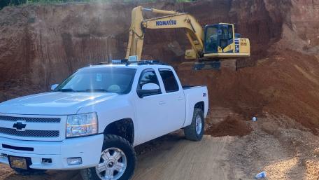 Heavy Machinery at Work with a White Pickup Truck wallpaper