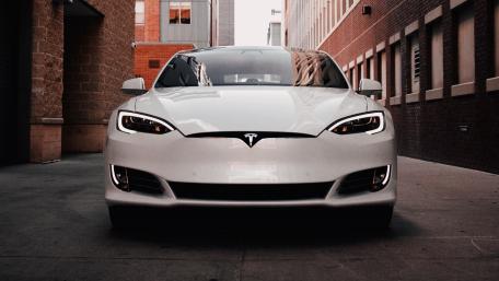 Sleek Tesla Model S Facing Forward in Urban Alleyway wallpaper