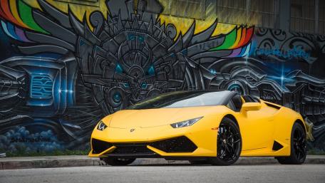 Vibrant Lamborghini Huracan Against Urban Graffiti Scene wallpaper