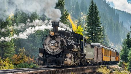 Vintage Steam Locomotive in Scenic Landscape wallpaper