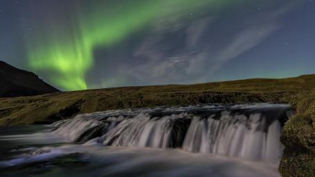 Mesmerizing Waterfall Under Northern Lights wallpaper