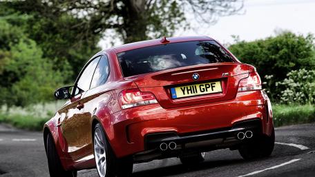 Sleek BMW Driving Through Scenic Landscape wallpaper