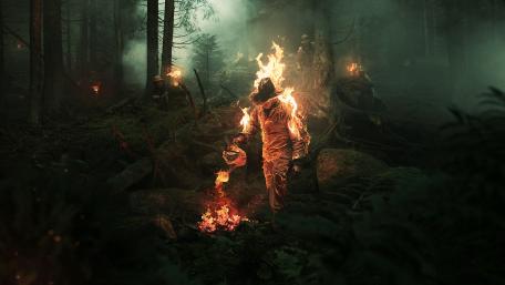 Enigmatic Fire Walker in Twilight Woods wallpaper