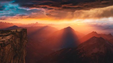 Stormy Sunset Over Rugged Peaks wallpaper