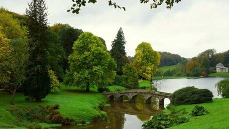 Serene Stone Bridge Over Tranquil River Scene wallpaper