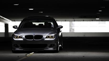 Sleek BMW in Shadowy Garage Setting wallpaper