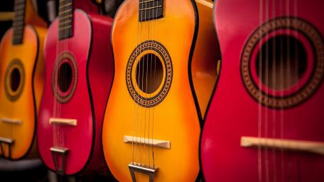 Vibrant Guitars Displayed in Harmony wallpaper