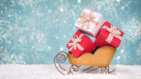 Festive Sleigh Loaded with Gifts for Christmas Celebration wallpaper