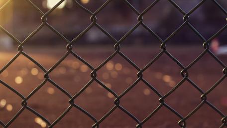 Urban Sunset Through a Wire Fence wallpaper