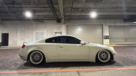 Sleek White Car in Urban Garage Setting wallpaper