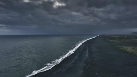 Dark Horizon Over Moody Shoreline wallpaper