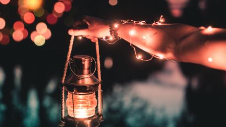 Warm Glow of Handheld Lantern at Night wallpaper