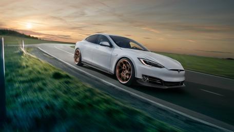 Sleek Tesla Model S on a Serene Highway Evening wallpaper