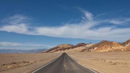 Endless Road Through Desert Landscape wallpaper
