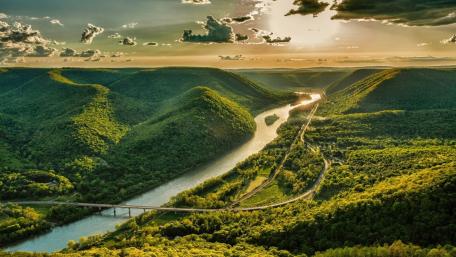Breathtaking Panoramic River View Amidst Lush Greenery wallpaper