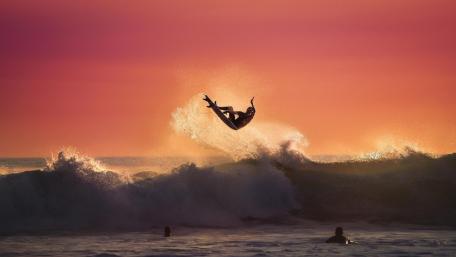 Sunset Ride on Majestic Waves wallpaper
