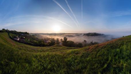 Misty Dawn Over Serene Hillside wallpaper