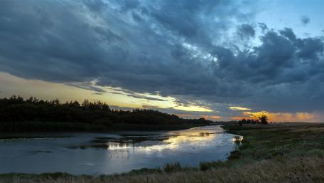 Majestic River at Dawn Across a Cloudy Sky wallpaper