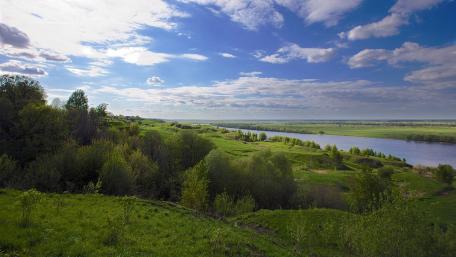 Serene River Landscape Under a Bright Sky wallpaper