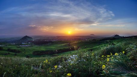 Breathtaking Sunrise Over Rolling Hills and Valleys wallpaper