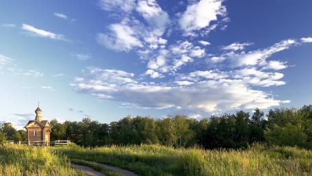 Serene Chapel Amidst Lush Grasslands wallpaper