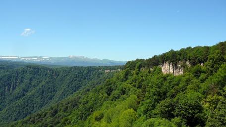 Majestic Green Mountains Under Clear Blue Sky wallpaper