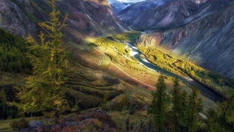Majestic Valley with Serene River in Nature's Embrace wallpaper