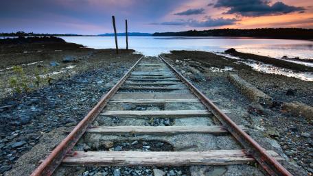 Serene Railway Tracks by the Water wallpaper