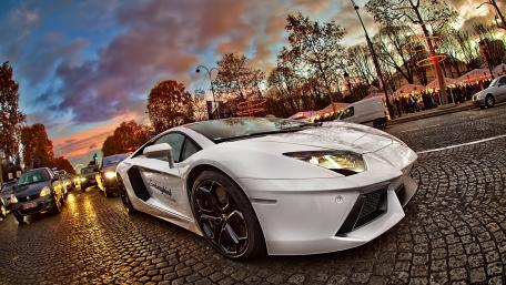 White Lamborghini Aventador on Cobblestone Street at Sunset wallpaper