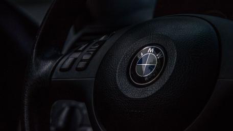 Sleek BMW Steering Wheel in Dark Interior wallpaper