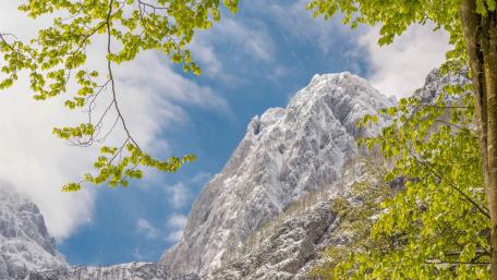 Majestic Mountain Peaks Under Clear Blue Sky wallpaper