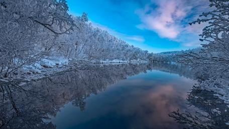 Serene Winter Reflection in Finland wallpaper