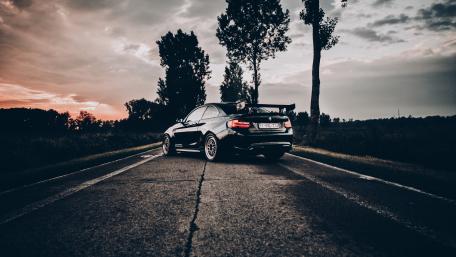 Sleek BMW on a Serene Road at Sunset wallpaper
