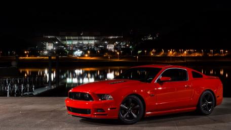 Sleek Red Ford Mustang Under Night Sky wallpaper