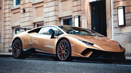 Sleek Gold Lamborghini Huracán in Urban Setting wallpaper