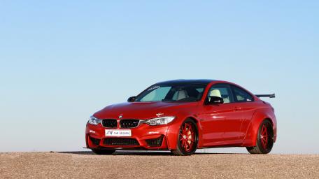Dynamic Red BMW M4 on Display wallpaper