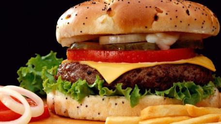 Juicy Burger Delight on Black Background wallpaper