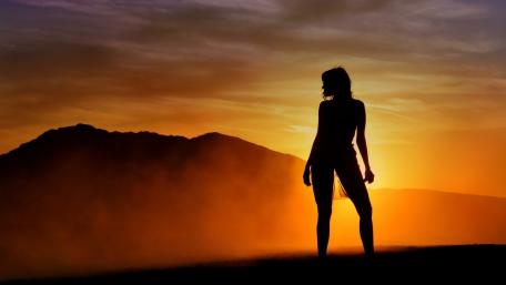 Serene Silhouette Against a Sunset Sky wallpaper