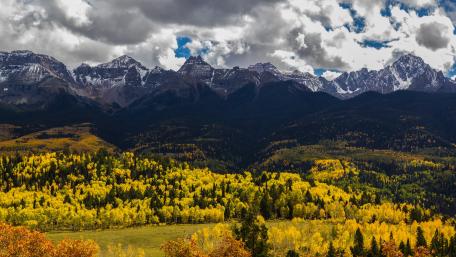 Majestic Autumn Mountains Under a Dramatic Sky wallpaper