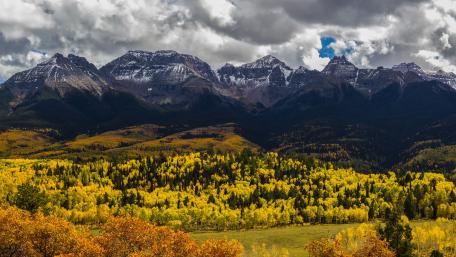 Majestic Autumn Mountains Under Dramatic Skies wallpaper