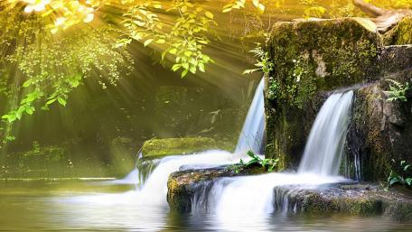 Golden Rays Over Serene Waterfall Scene wallpaper