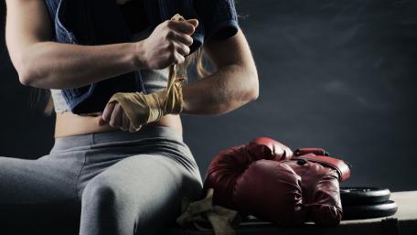 Empowered Female Boxer Preparing for Fight wallpaper