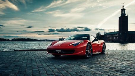 Sleek Ferrari by the Waterfront Under Dramatic Skies wallpaper